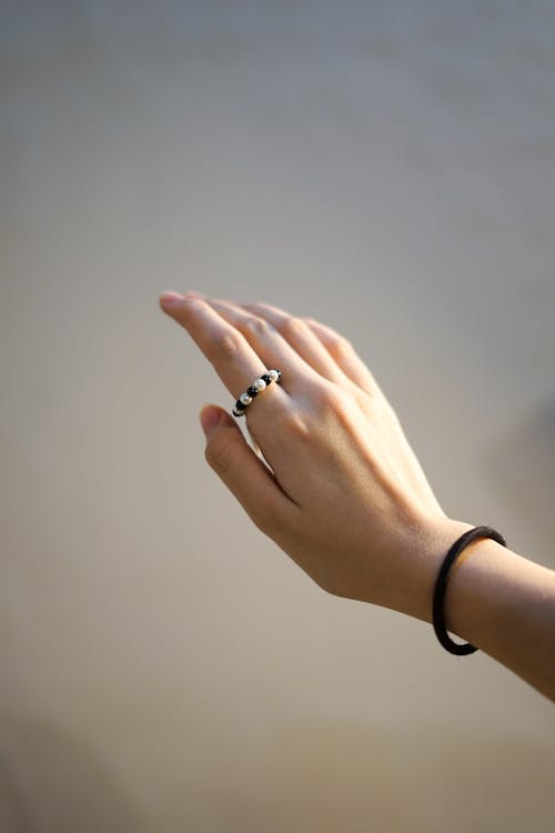 Free Photo of a Person's Hand with a Black and White Ring Stock Photo