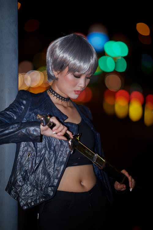 Woman Wearing Black Leather Jacket While Holding A Sword 