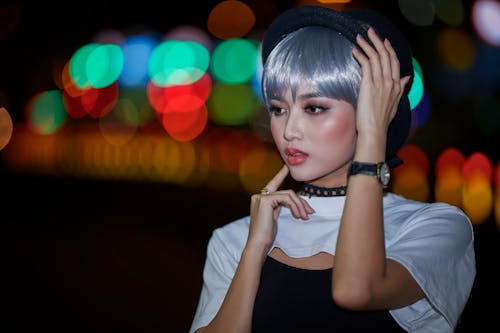 A Gray Haired Woman Wearing a Hat Posing