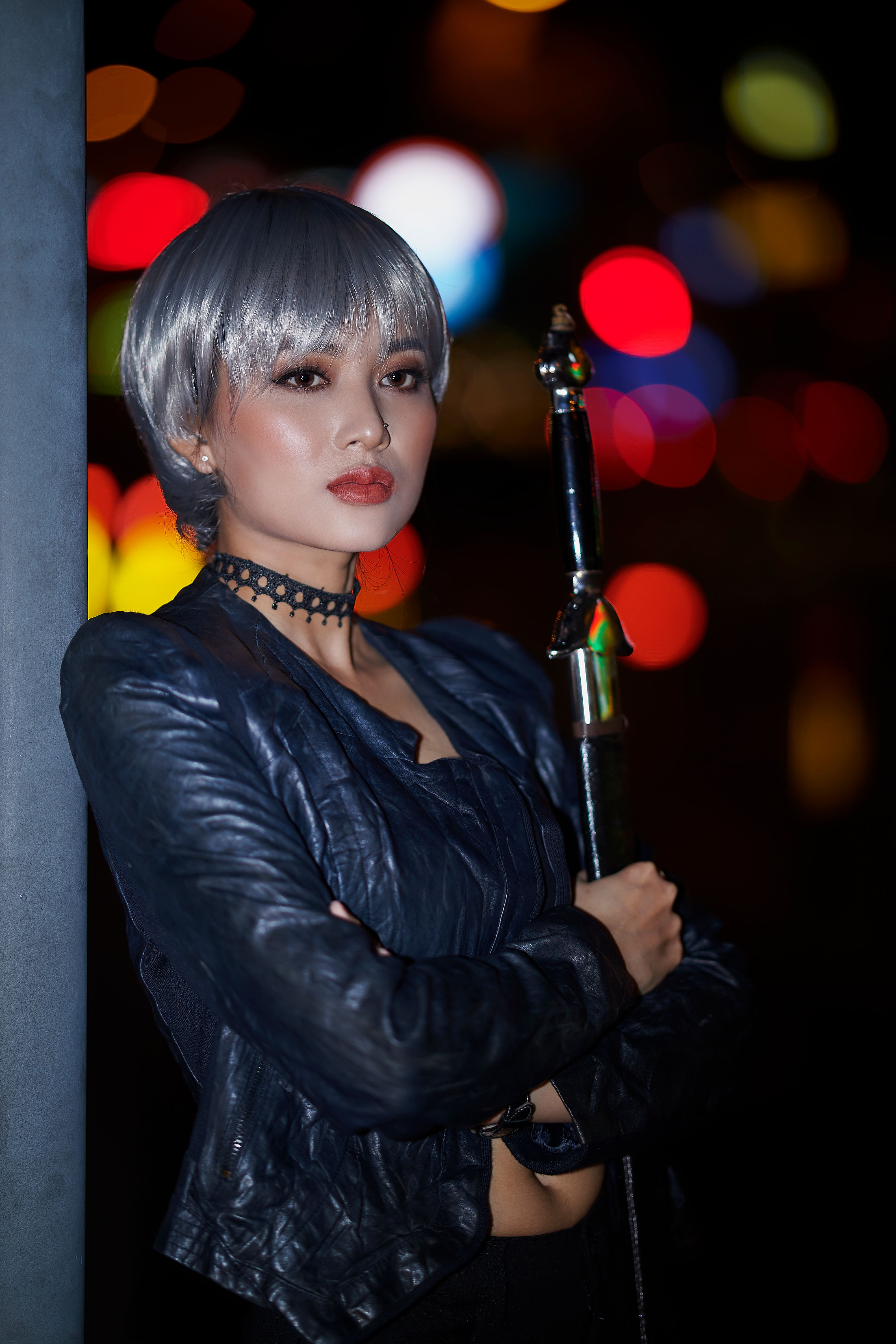 A Woman in Black Leather Jacket Holding a Sword