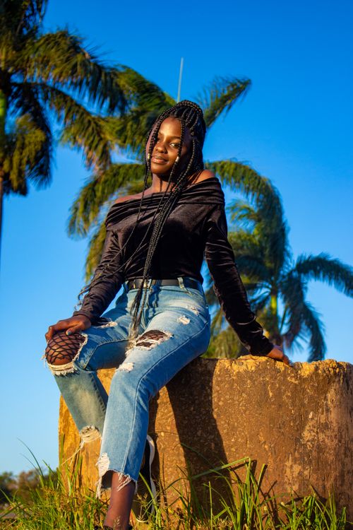 Free A fashionable young woman in denim poses outdoors in Kampala, Uganda. Stock Photo