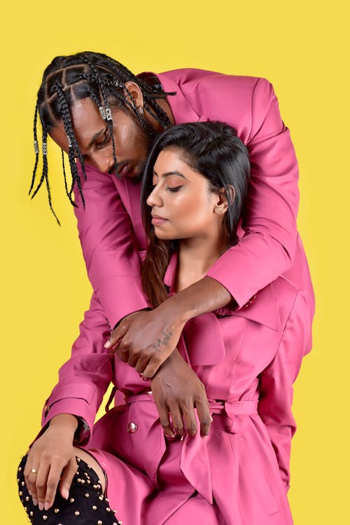 Man and Woman Wearing Pink Outfit Posing