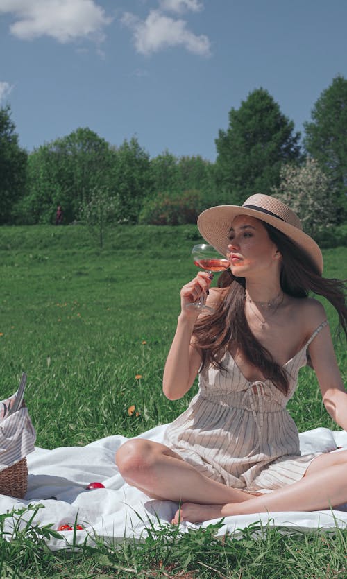 Woman Drinking While in a Picnic