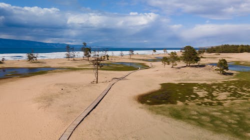 Land on Riverside under Cloudy Sky 