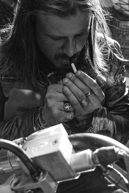 Grayscale Photo of Man Smoking Cigarette