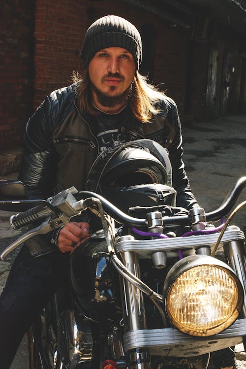 Man in Black Leather Jacket Sitting on Motorcycle 