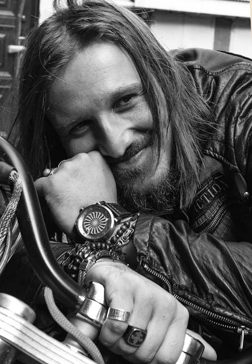 Grayscale Photo Of Smiling Man in Black Leather Jacket 