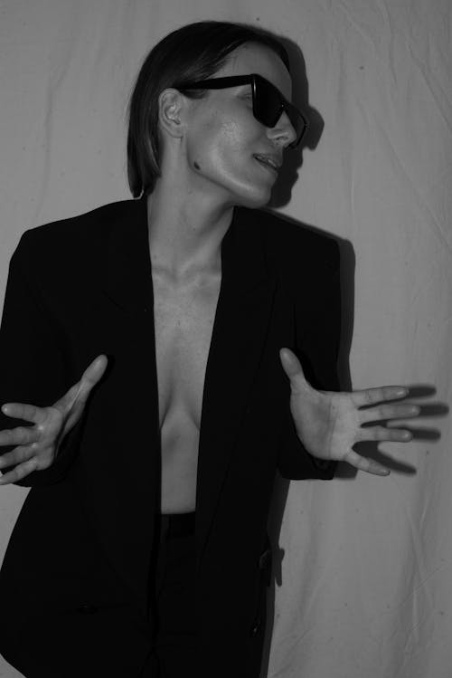 Free Monochrome Photo of a Woman Wearing a Black Blazer and Sunglasses Stock Photo