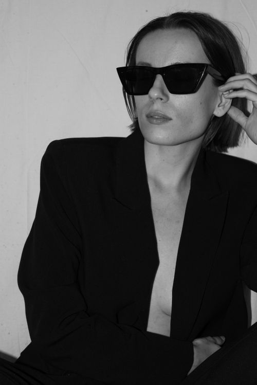 Free Black and white portrait of a woman wearing sunglasses and a black blazer. Stock Photo