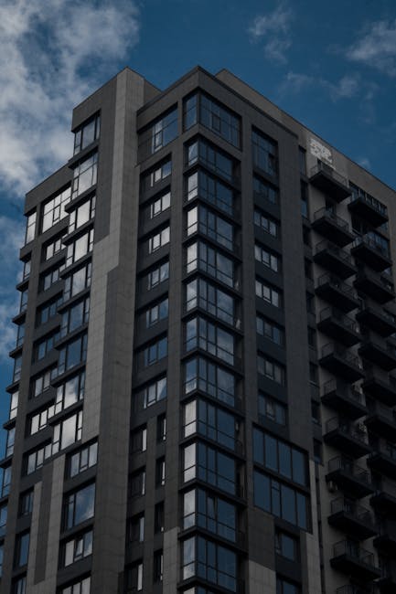 Grey Concrete Round High Rise Building · Free Stock Photo