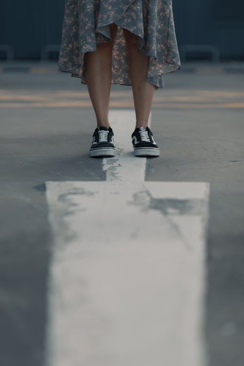 Low-Angle Shot of a Woman Wearing Black and White Sneakers