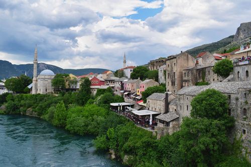 Free Picturesque view of historic buildings in Mostar, Bosnia and Herzegovina by the river. Stock Photo