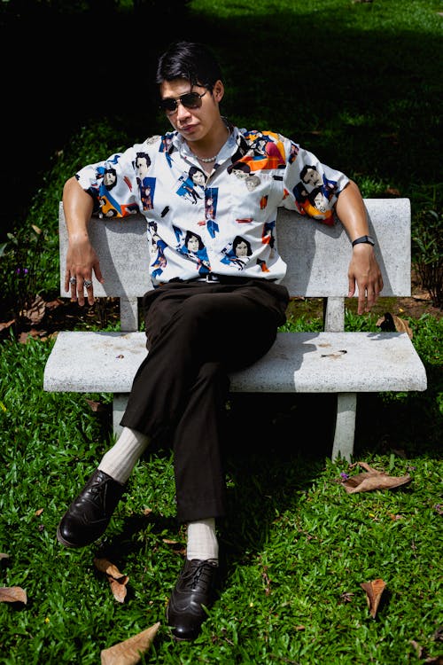 Stylish Man sitting on a Concrete Bench 