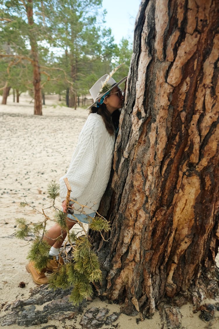 Photo Of A Woman Leaning On A Tree Trunk