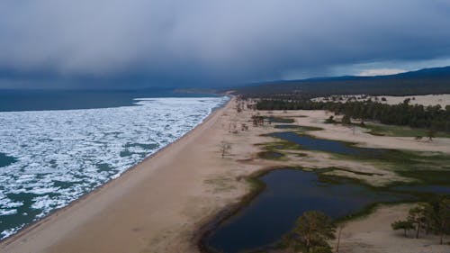 Bird's Eye View of Seashore Under Cloudy Sky