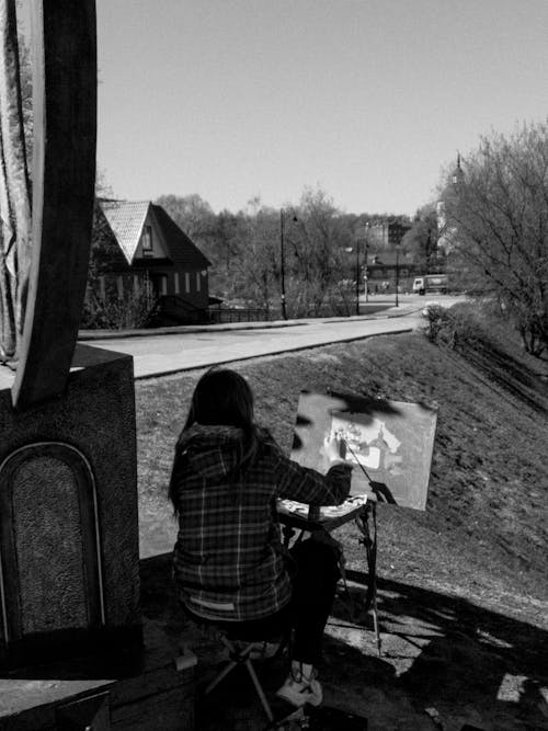 Grayscale Photo of a Person Doing an Artwork