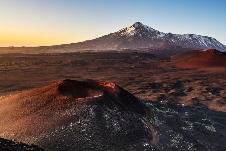 Volcanic plain venting steam at dusk. Photo by Pavel on Pexels