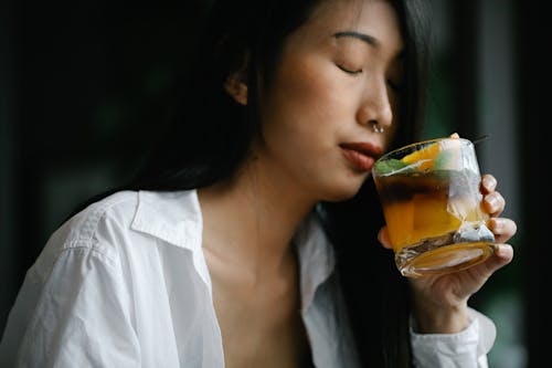 Free Woman in White Dress Shirt Holding An Alcoholic Beverage Stock Photo