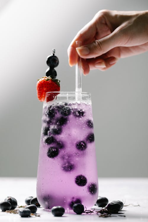 Free Clear Drinking Glass with Purple Liquid Stock Photo