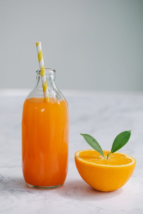 Free Orange Juice in Clear Glass Bottle Stock Photo