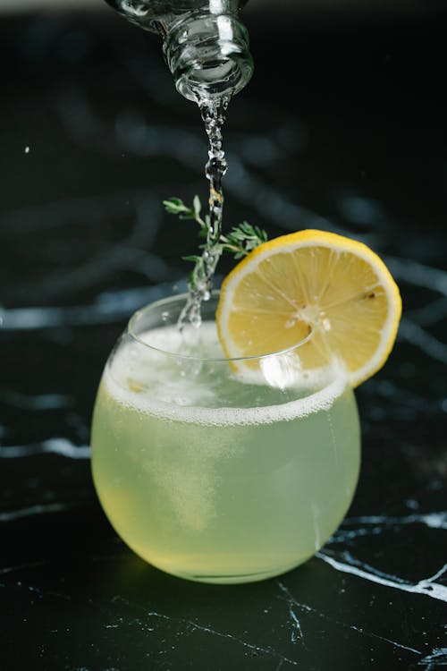 Free Cocktail Drink In Clear Glass With Slice of Lemon Stock Photo