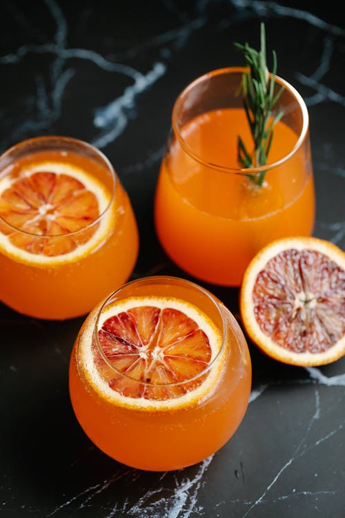 Free Orange Juice in Drinking Glasses Stock Photo