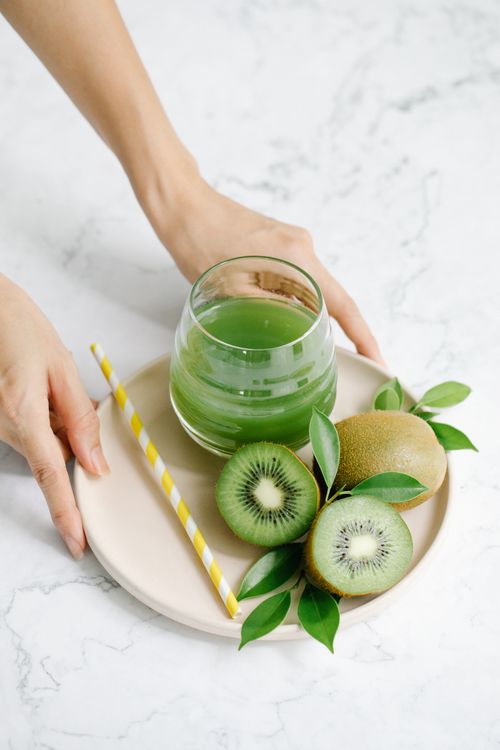 Free Bright and healthy kiwi juice with fresh fruits, served on a marble table for a refreshing feel. Stock Photo