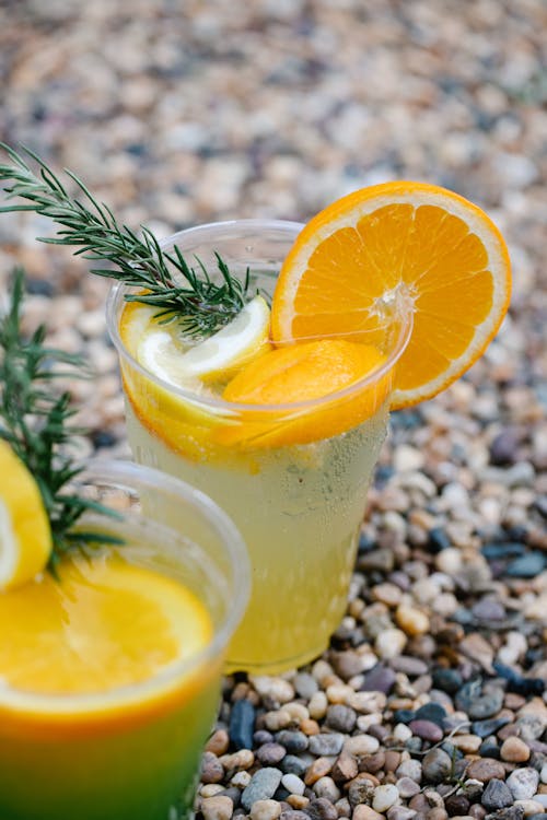 Free Clear Drinking Cup With Lemonade and Orange Slices Stock Photo