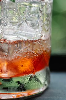Chilled drink with ice cubes and bubbles, perfect for refreshment.