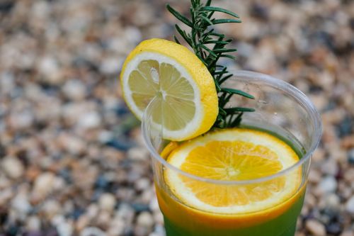 Free Close-up of a refreshing citrus drink garnished with lemon slices and rosemary. Stock Photo