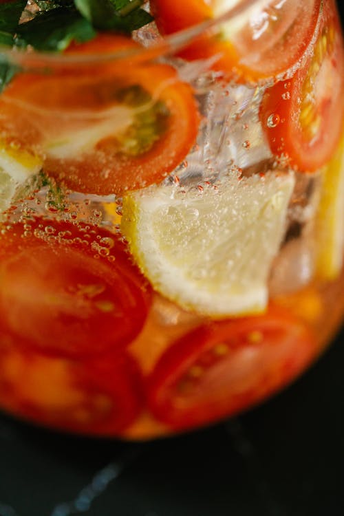 Sliced Lemon on Clear Glass With Cherry Tomatoes