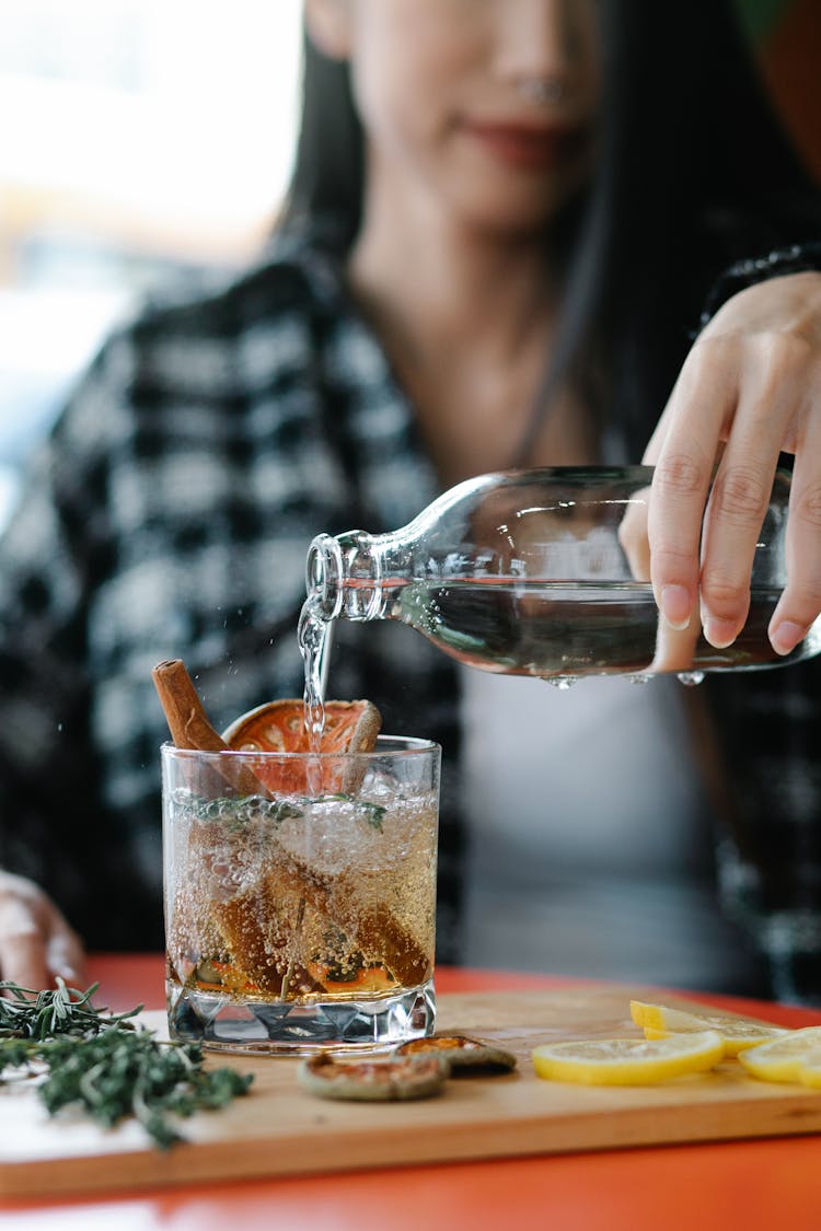 Woman Pouring Water To Glass