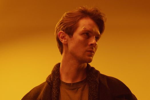 A Man in a Coat Looking Sideways