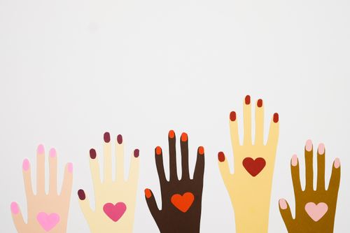 Free Illustrated hands of diverse colors with hearts symbolizing equality and unity. Stock Photo