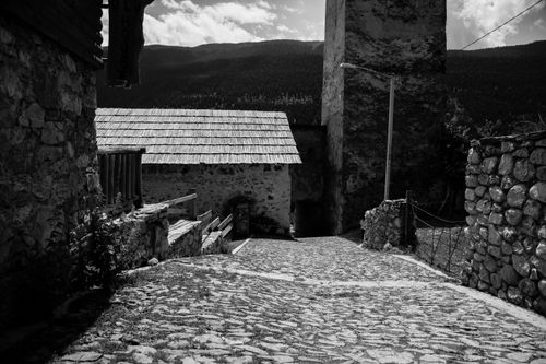 Free Black and white photo of a cobblestone street in the historic village of Mestia, Georgia. Stock Photo