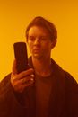 Woman in Brown Scoop Neck Shirt Holding Black Smartphone