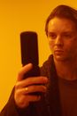 Man in Black Crew Neck Shirt Holding Black Rectangular Device