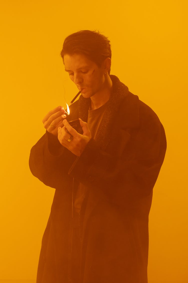 Man Lighting A Cigarette With A Matchstick