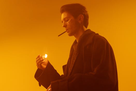 A stylish man in a smokey studio setting, creating a moody and atmospheric image.