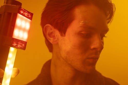 Close-up Photo of Man holding a Portable Light