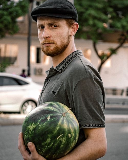 Free A man in Gaziantep holding a watermelon on a bustling street. Stock Photo