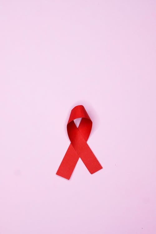 Red Ribbon on Pink Surface