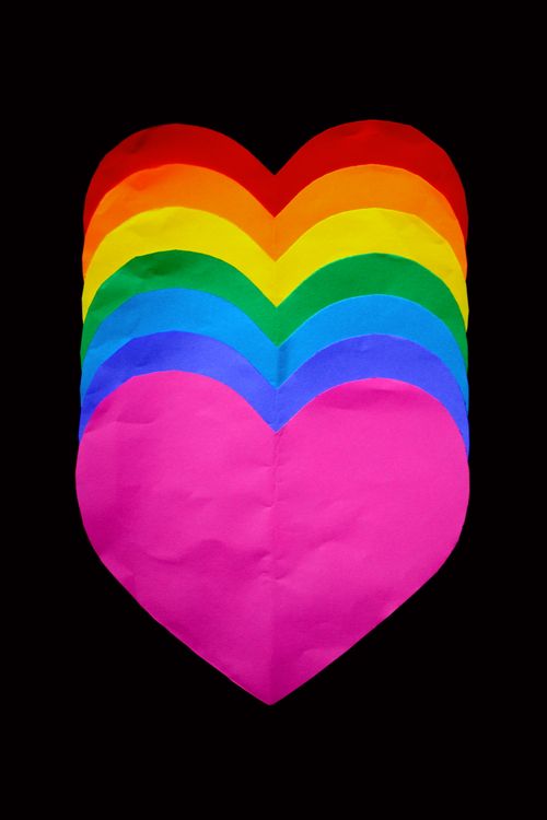 Free A vibrant heart shape in rainbow colors on a black background symbolizing LGBTQ pride and unity. Stock Photo