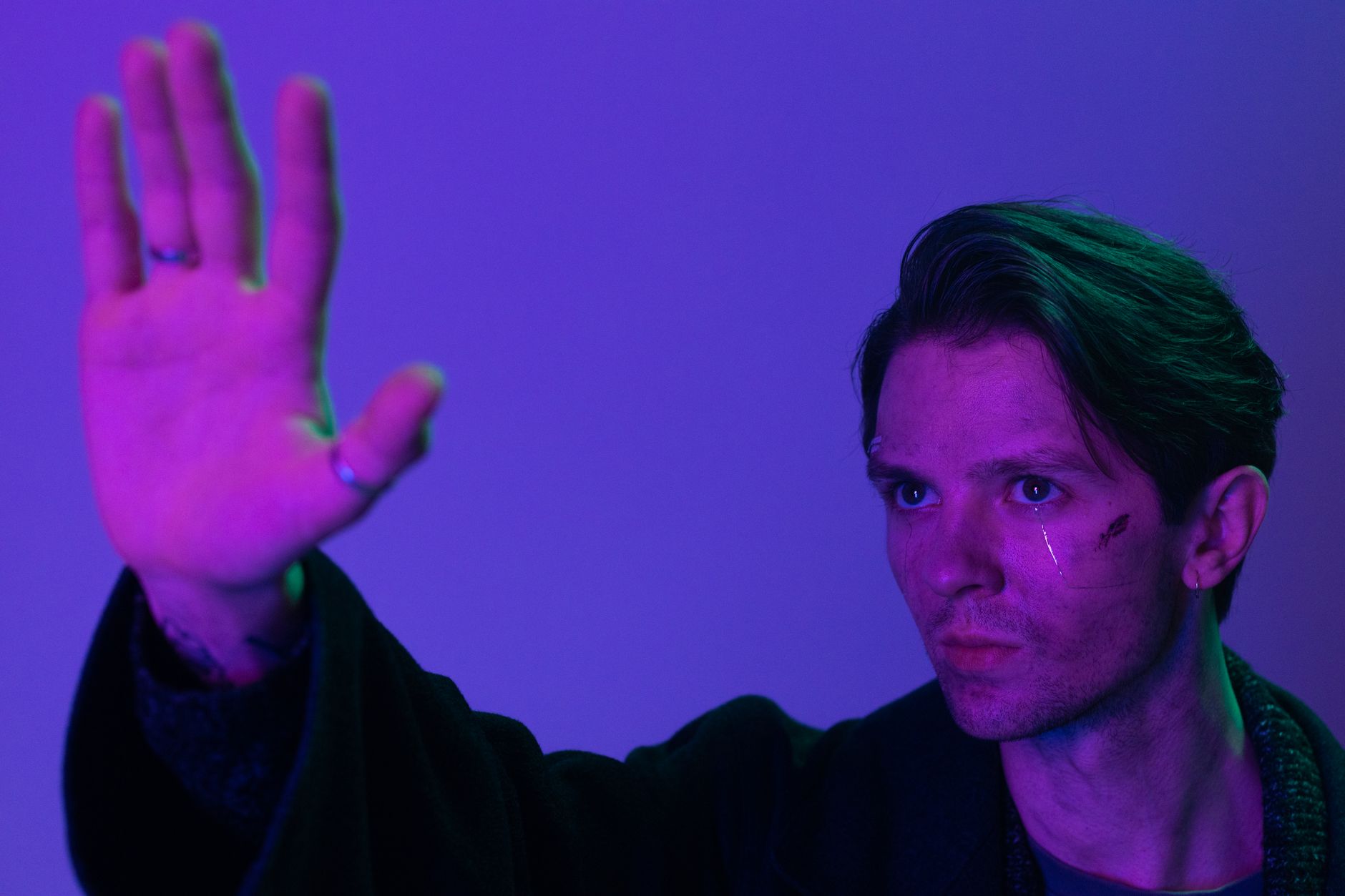 A striking portrait of a man with neon lighting, reflecting cyberpunk aesthetics.