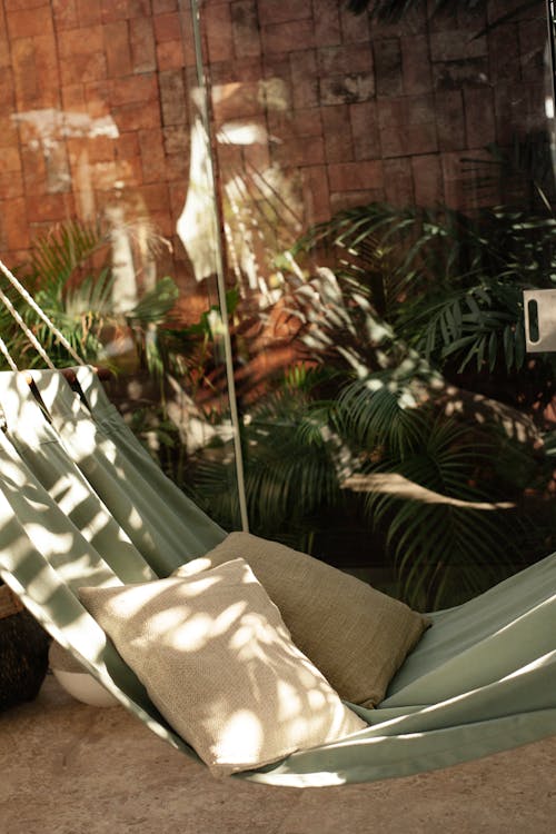 Green Hammock With Throw Pillows In A Terrace