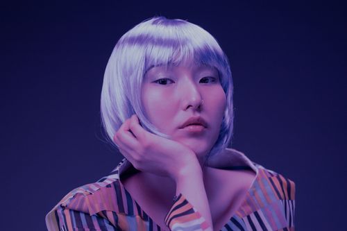 Free Close-up portrait of a woman with silver hair and nose ring in a modern studio setting. Stock Photo