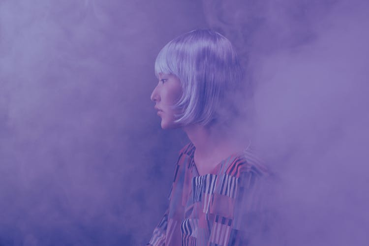 Woman In Printed Blouse Covered In Smoke 