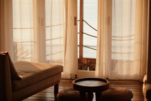 Warm sunlit lounge area with beach view for a relaxing vacation.