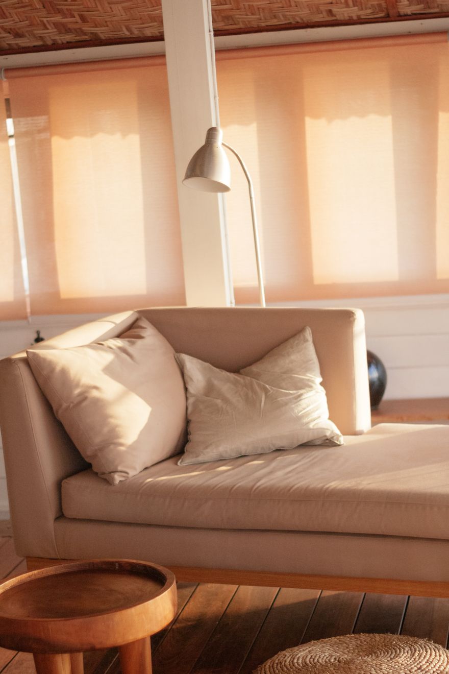 Sunlit consulting room with a linen sofa, cushions and an arc floor lamp. Photo by Ksu&Eli Studio on Pexels.