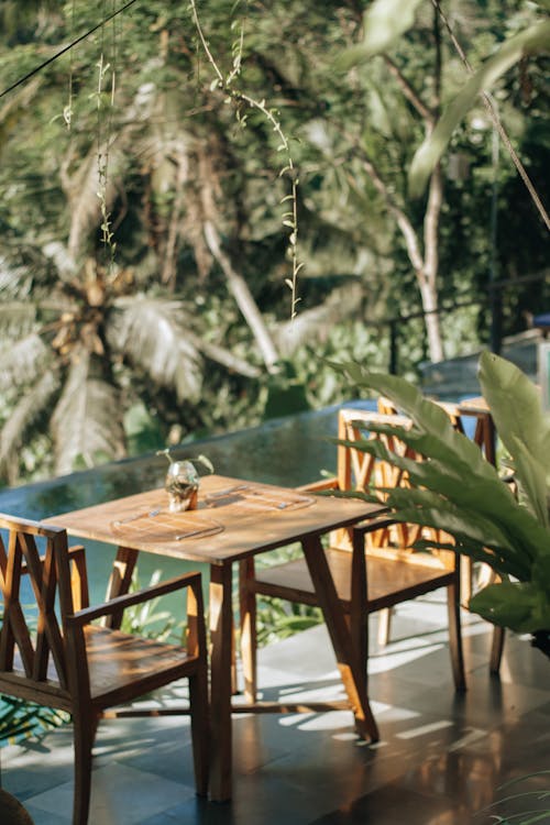 Brown Wooden Table and Chairs by the Pool